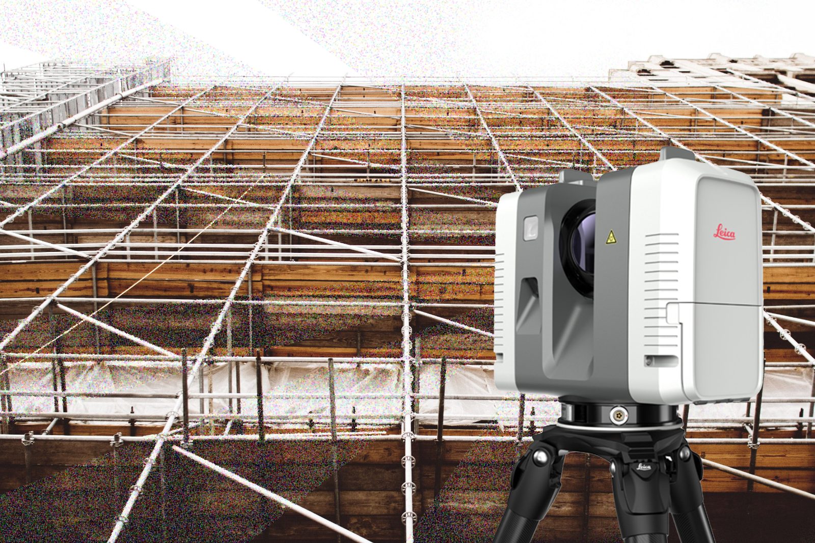 Leica laser scanner in front of a scaffolded construction facade